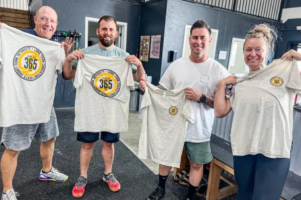 One Shot Wellness People Showing Shirts With Logo
